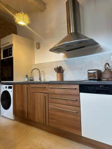 a kitchen with a sink and a stove at La Cabane in Dambach-la-Ville