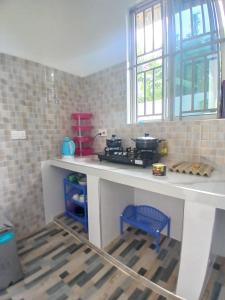 a kitchen with a stove and a counter top at Sun House Kendwa in Kendwa