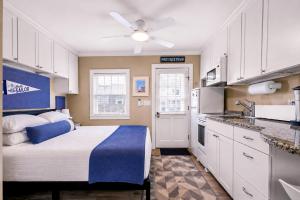 a small kitchen with a bed in a room at Waterfront Studio - Bay Views, Steps to Comm St in Provincetown