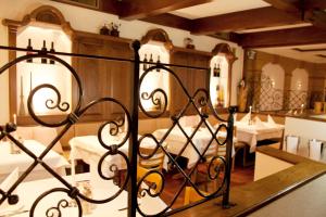 a dining room with white tables and chairs at Stadthotel Erding in Erding