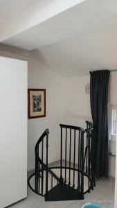 a room with two black stools next to a window at La Romanina in Bagnone