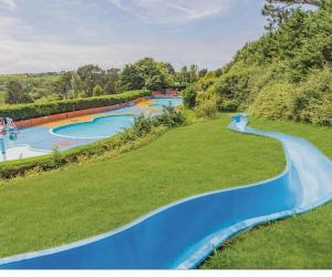 an image of a water park with two slides at Newquay - Deluxe 3 bed Lodge Willows Way 47, Newquay Parkdean, Holiday Park in Newquay