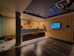 a room with a tv on a wall at HOTEL PARADISe in Guwahati