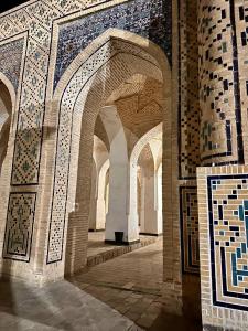 an archway in a building with mosaics on it at Nabibek boutique in Bukhara
