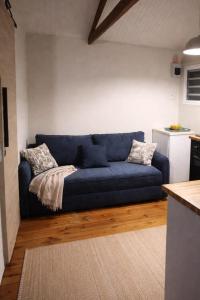 a blue couch sitting in a living room at sunset lovers cottage in Canefield +12 photos