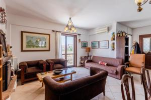 a living room with a couch and a table at Demie's Maisonette in Plytra with SeaView in Plytra