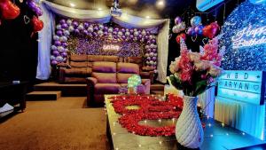 a room with a table with a vase filled with flowers at Urban Space in Khammam