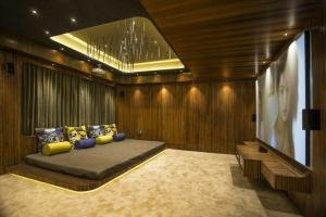 a bedroom with a bed in a room with wooden walls at Urban Space in Khammam