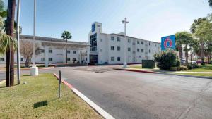 an empty street in front of a large building at Motel 6-Brownsville, TX in Brownsville