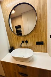 a bathroom with a white sink and a mirror at Słoneczny Taras in Kęty +7 photos