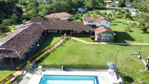 an aerial view of a house with a swimming pool at Villa Beatriz in Palestina