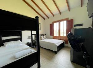 a bedroom with two bunk beds and a window at Villa Beatriz in Palestina
