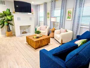 a living room with a blue couch and a fireplace at Heavenly Hideaway in Daytona Beach