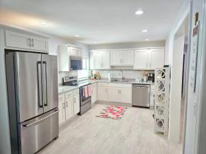 a kitchen with white cabinets and stainless steel appliances at Heavenly Hideaway in Daytona Beach