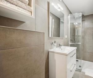 a bathroom with a white sink and a shower at Prime Host Dream Apartment in Karlsruhe