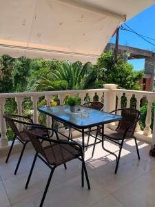 a blue table and chairs on a balcony at Miminllari APARTMENTS 2 in Pefkochori