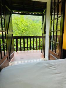 a bed in a room with a open door at Mountain View Guest House,Geres in Geres +31 photos