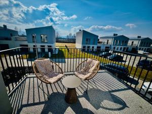 two chairs and a table on a balcony at Słoneczny Taras in Kęty