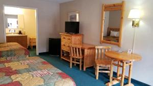 a hotel room with two beds and a table and a mirror at Keystone Boardwalk Inn and Suites in Keystone +24 photos