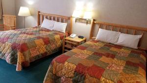 a hotel room with two beds and a phone at Keystone Boardwalk Inn and Suites in Keystone