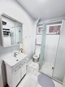a bathroom with a shower and a sink and a toilet at Lucky apartman in Šabac