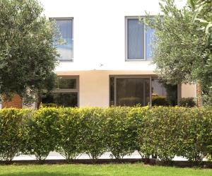 a house with bushes in front of a building at Vabel Skiathos in Skiathos