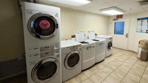 a row of washing machines in a laundry room at Studio 6-Brownsville, TX in Brownsville