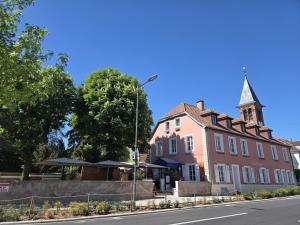 a building with a steeple on the side of a street at Les Terrasses Sainte Odile - Centre ville - Climatisation - Parking Privatif - Gare in Obernai