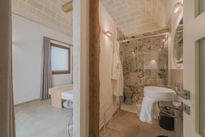 a bathroom with a tub and a sink in a room at Setteminne Resort Design in Favignana +45 photos