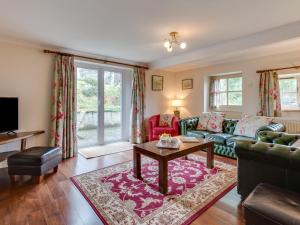 a living room with a couch and a table at 3 Bed in Swansea oc-bn172 in Ystalyfera