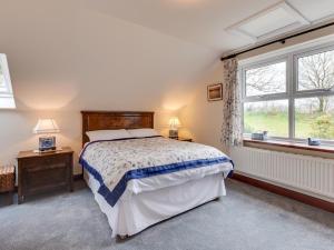 a bedroom with a bed and a window at 3 Bed in Swansea oc-bn172 in Ystalyfera