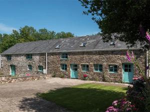 an old stone building with blue doors and windows at 3 Bed in Swansea oc-bn172 in Ystalyfera