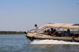 a group of people riding on a boat on the water at Murighiol Excursii in Murighiol