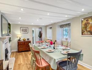 a dining room with a table and chairs at Sharpe Cottage Wiveliscombe in Wiveliscombe