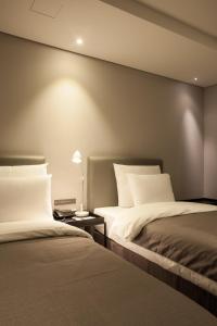 Postel nebo postele na pokoji v ubytování Hotel Gaden