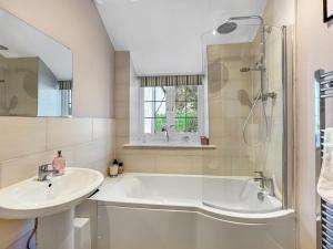 a bathroom with a tub and a sink and a shower at Sharpe Cottage Wiveliscombe in Wiveliscombe +21 photos