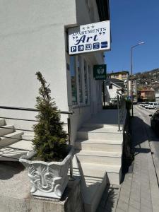 a plant in a pot on the side of a building at Apartmani Art in Jajce