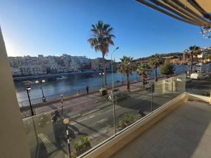 a view of a city with a river and palm trees at Luxury Waterfront 3BR Apartment with Large Terrace in Marsaskala