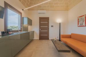 a living room with a couch and a table at Setteminne Resort Design in Favignana