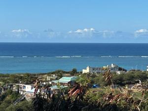a view of the ocean with buildings and a city at Eagle Nest Residence -Appartement 1 in Port Maturin