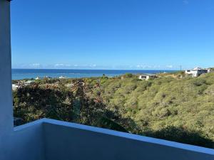 a view of the ocean from the balcony of a house at Eagle Nest Residence -Appartement 1 in Port Maturin