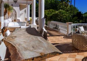 a wooden table on a porch of a house at Tranquil Algarve Escape in Faro