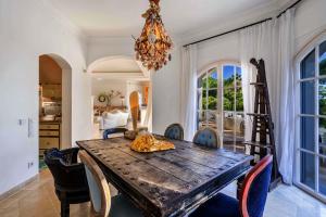 a dining room with a wooden table and chairs at Tranquil Algarve Escape in Faro