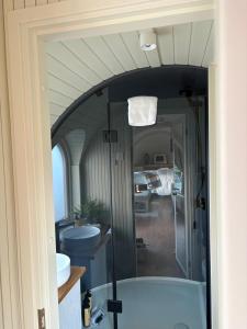 a bathroom with a bath tub and a sink at The Hare's Lair in Monaghan