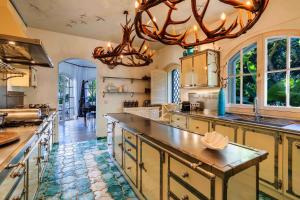 a large kitchen with a chandelier and a large counter at Tranquil Algarve Escape in Faro +4 photos