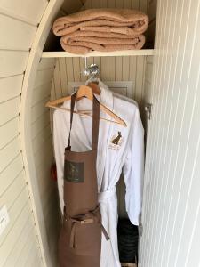 a closet with a shirt and apron on a shelf at The Hare's Lair in Monaghan