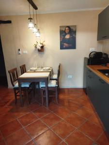 a dining room with a table and chairs and a kitchen at Studio Lanisa in Kanal +13 photos