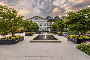 a courtyard with a fountain in front of a building at 124 on Queen Hotel & Spa in Niagara-on-the-Lake