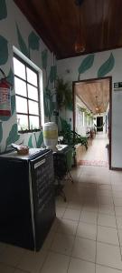 a kitchen with a counter with a chalkboard on the wall at Caiçara Guest House in Ubatuba