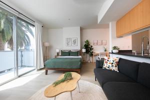 a living room with a couch and a bed at Central Penthouse Studio with Free Parking in Los Angeles +23 photos